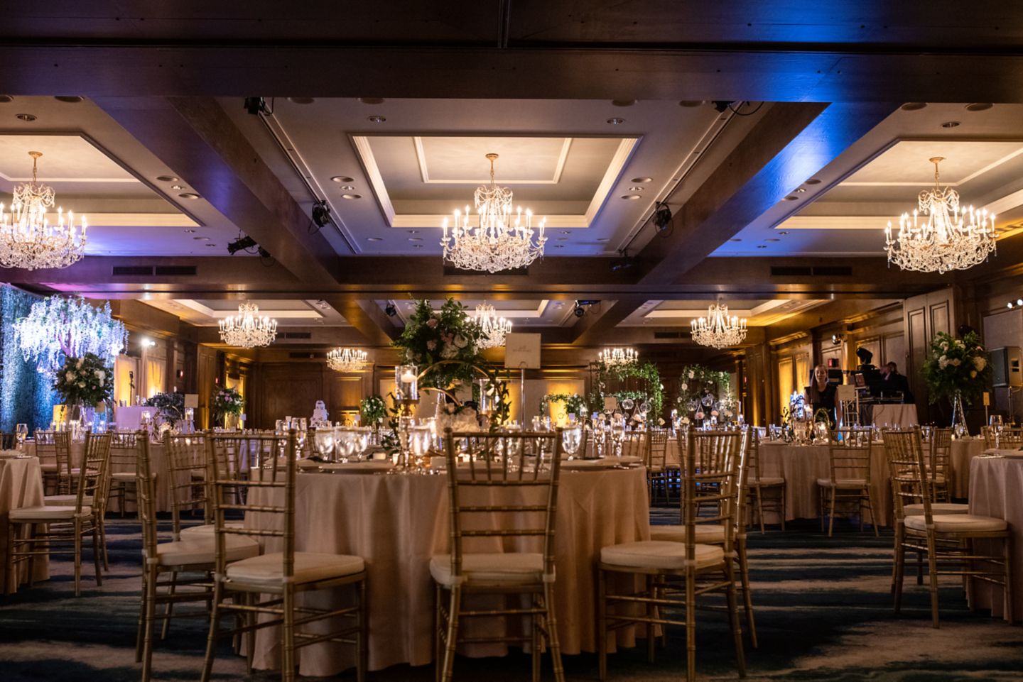 a wedding reception setup in a grand ball room