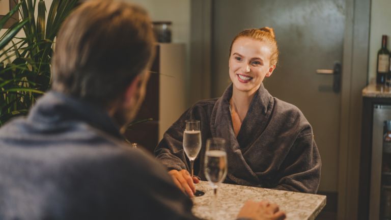 Woman and man in Kohler Waters Spa Cafe drinking champagne