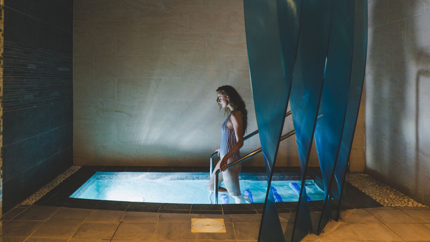 Woman walking into Kohler Waters Spa plunge pool