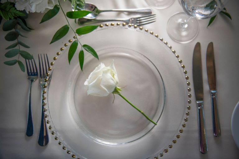 White rose on a charger plate. Weddings at the Old Course Hotel, Golf Resort & Spa