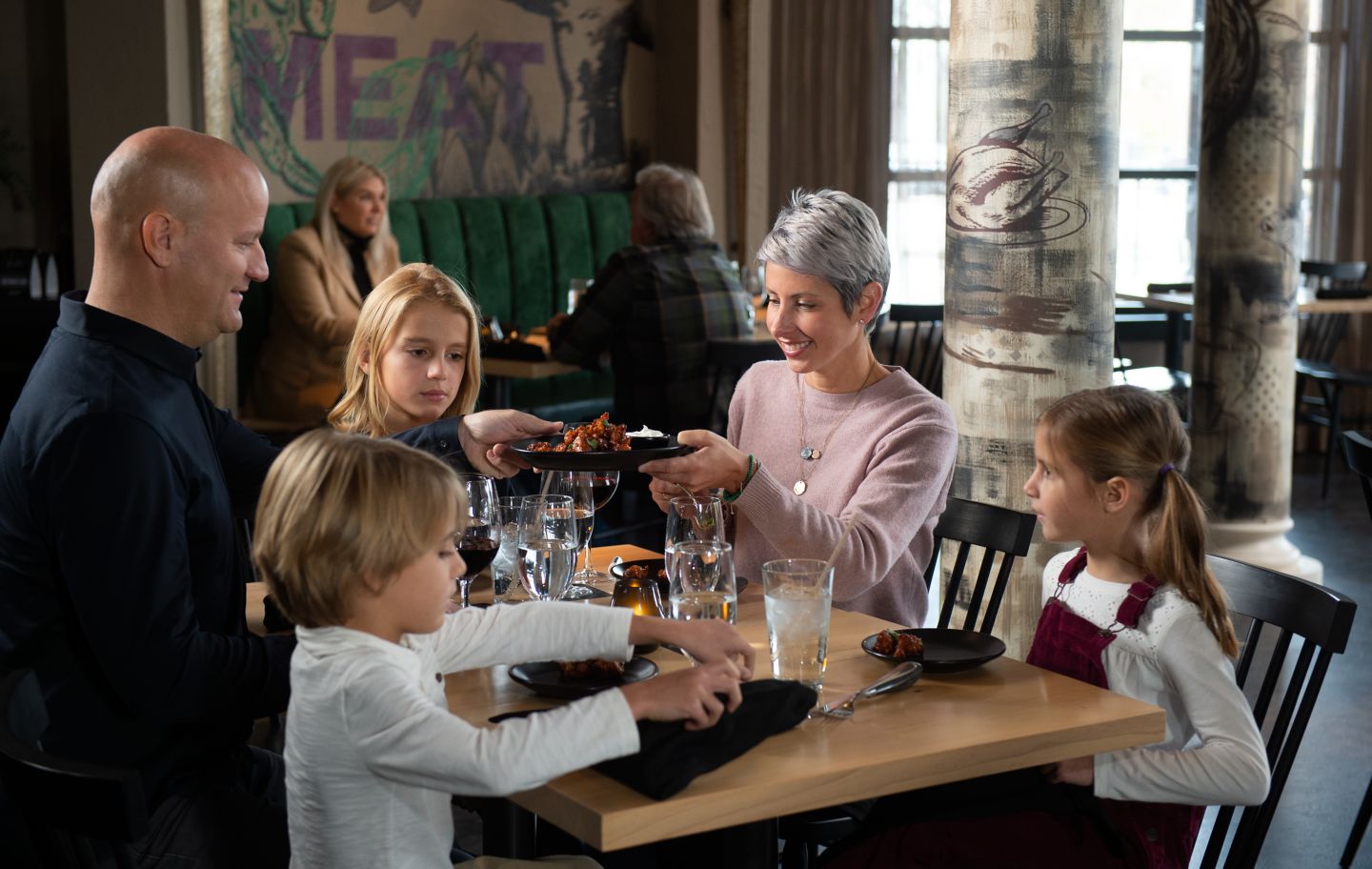 a family enjoying lunch at a table at Taverne on Woodlake