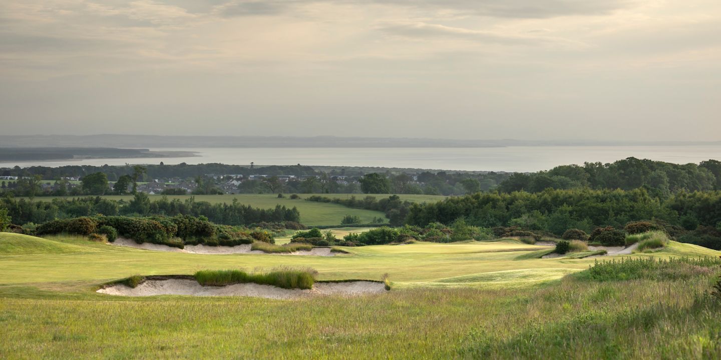 No. 13 Braw View. Looking towards the 13th green at The Duke's over a deep bunker with views of St Andrews in the background.
