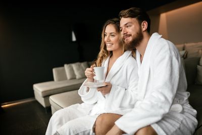 Couple enjoying a cup of tea in their bathrobes
