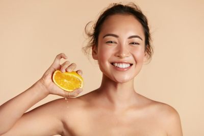 Woman squeezing an orange