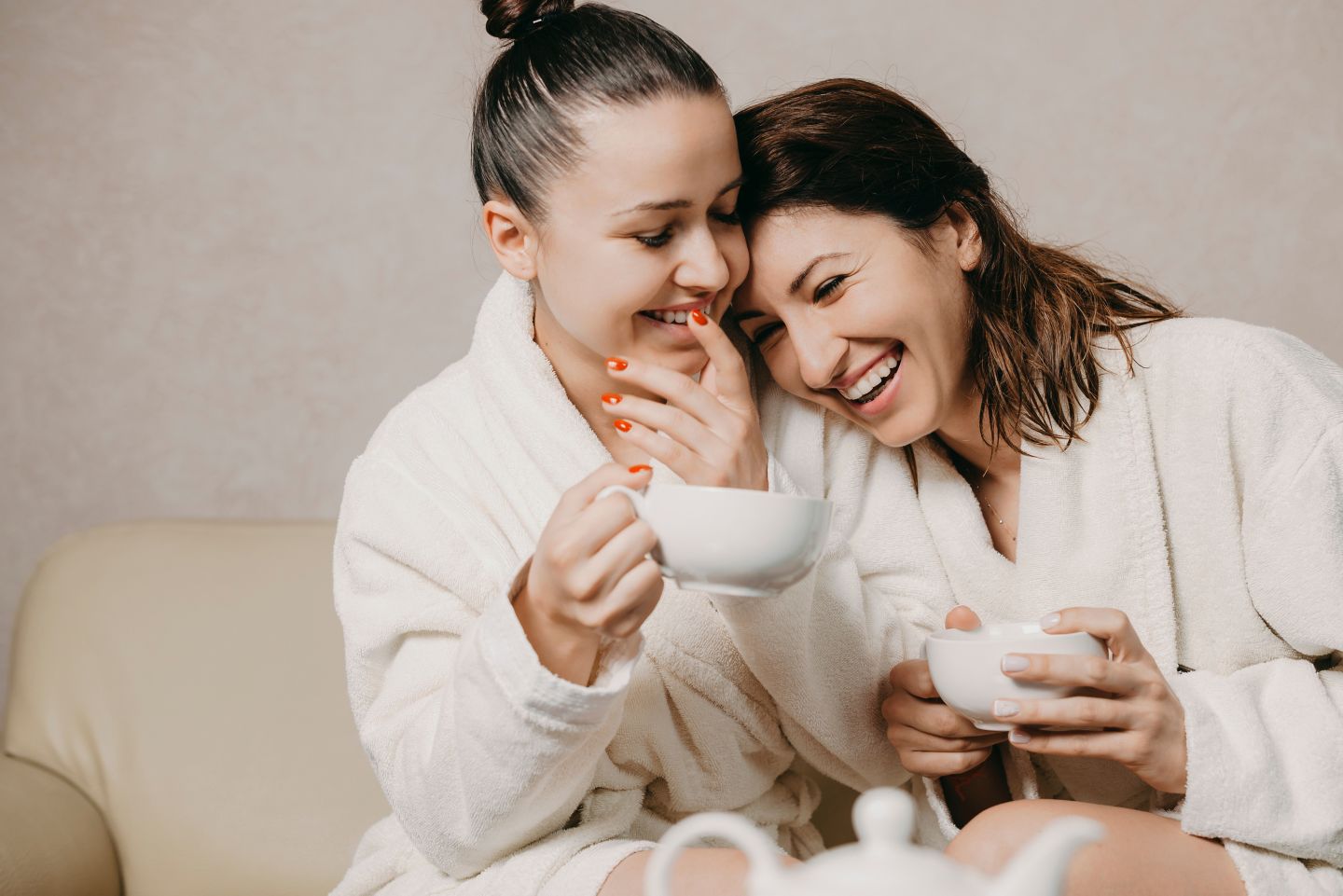 Mother and daughter enjoying tea in a spa