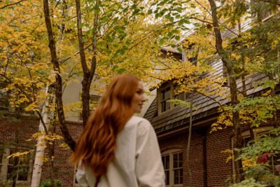 A woman in a courtyard with fall colors