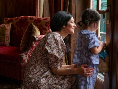 a mother and daughter looking out the window