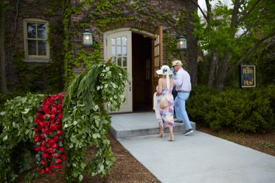 a couple walking into the horse & plow for a Kentucky Derby Party