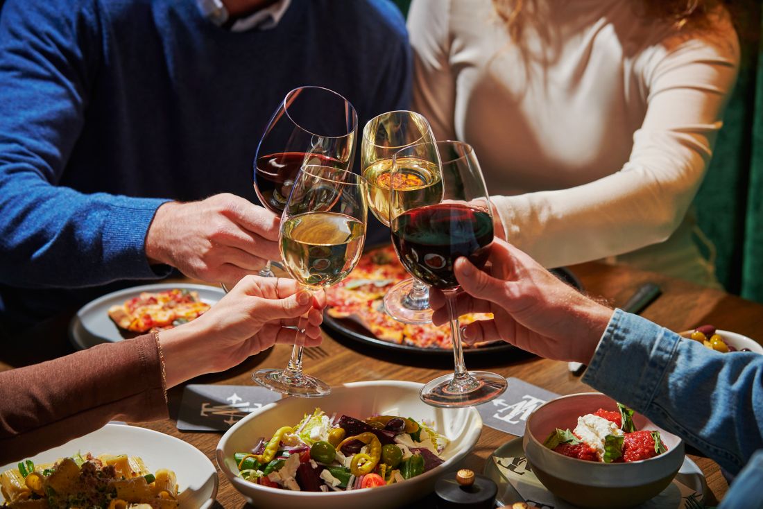 a table full of pizza and drinks