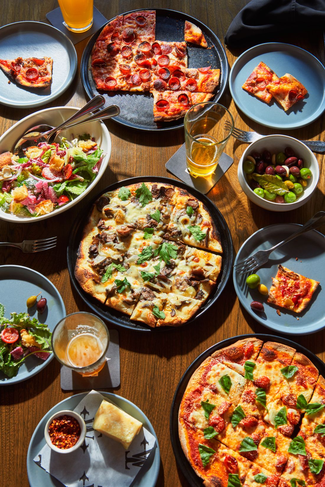 a table full of pizza and drinks