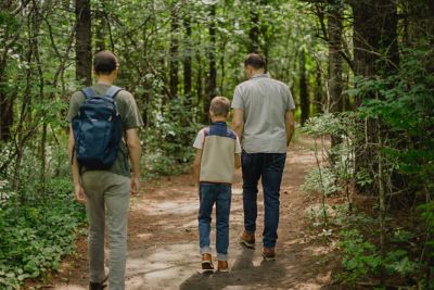 a father and kids hiking through the woods