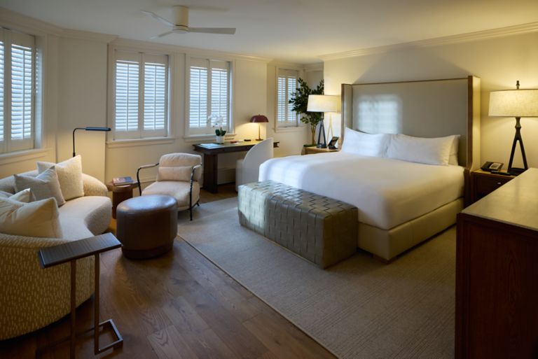 a king bed in a Carriage House Immersion Suite