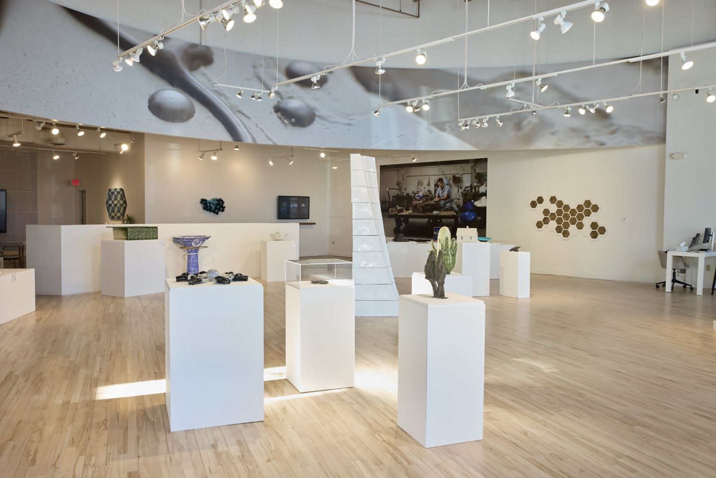 a woman walking through an art exhibit