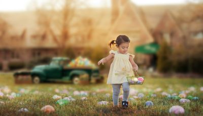 A little girl laughing with bunny ears on