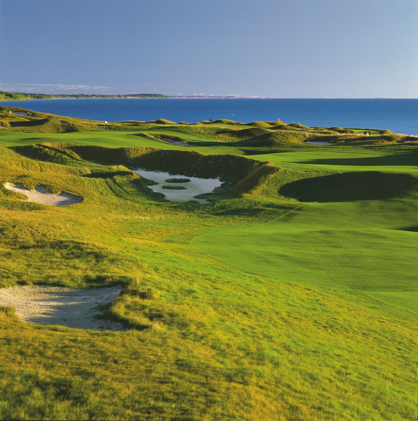 A few of the green with bunkers and water of the eleventh hole of the Straits Course at Whistling Straits.
