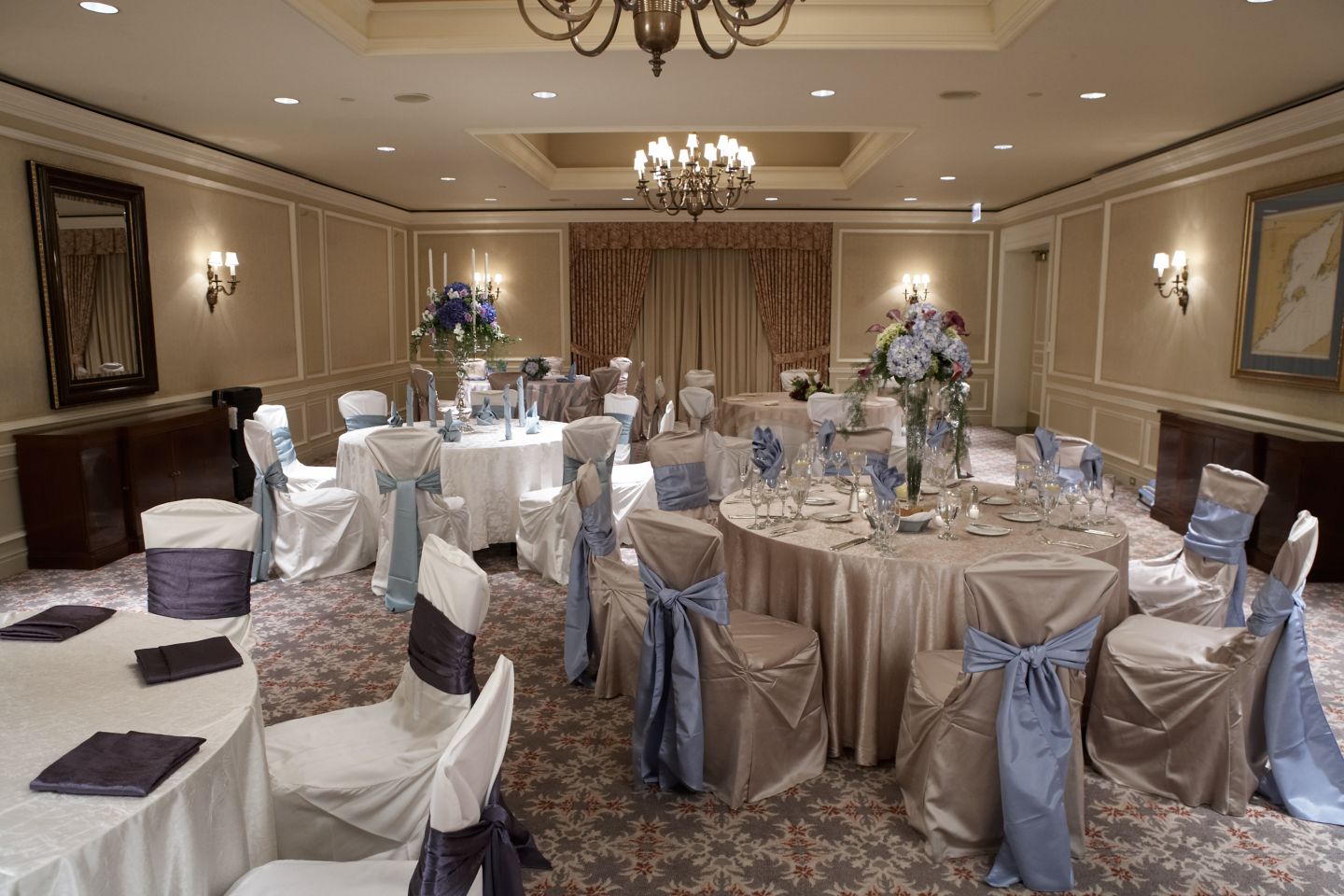 a wedding reception setup in a medium sized ball room