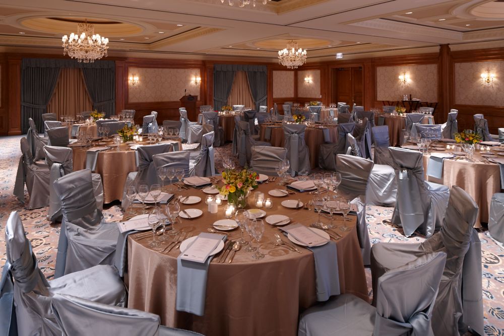 a wedding reception setup in a medium sized ball room
