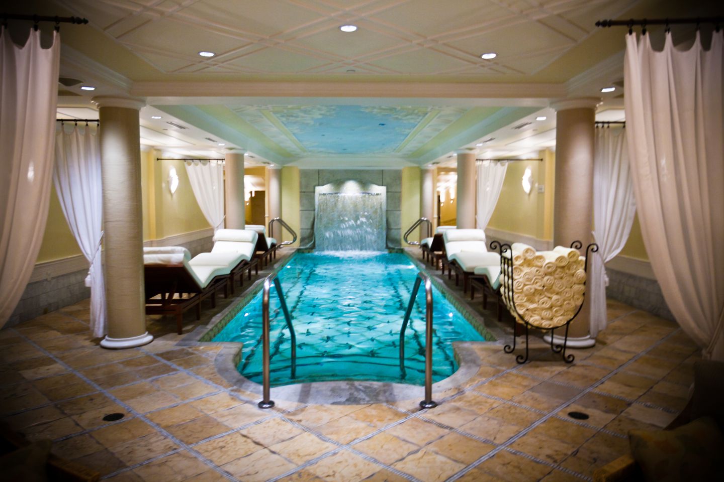 an indoor pool with a waterfall 