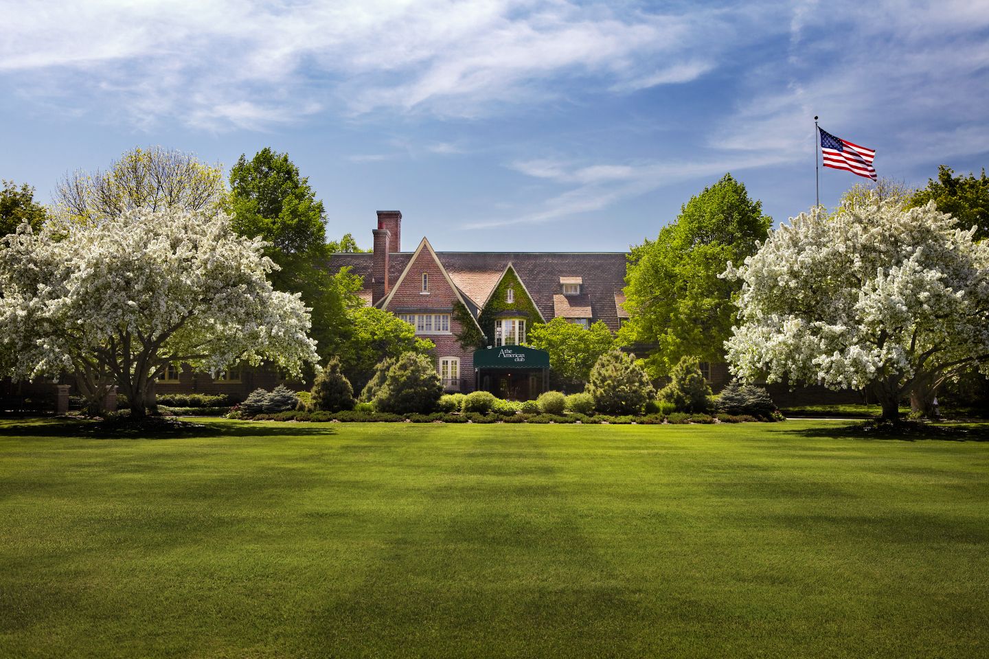 a seasonal spring scene of the exterior of The American Club 