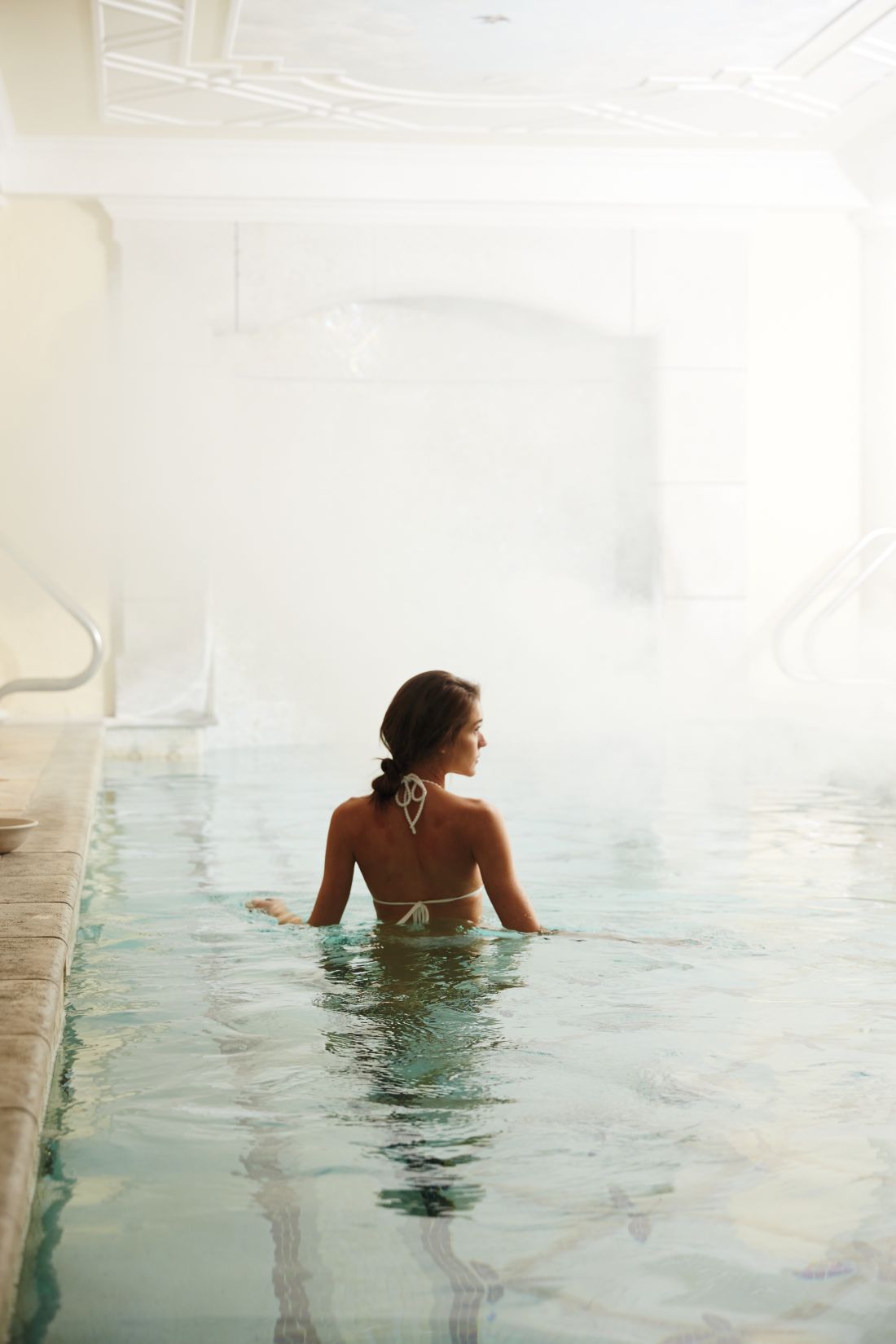 a woman in a calming spa pool environment