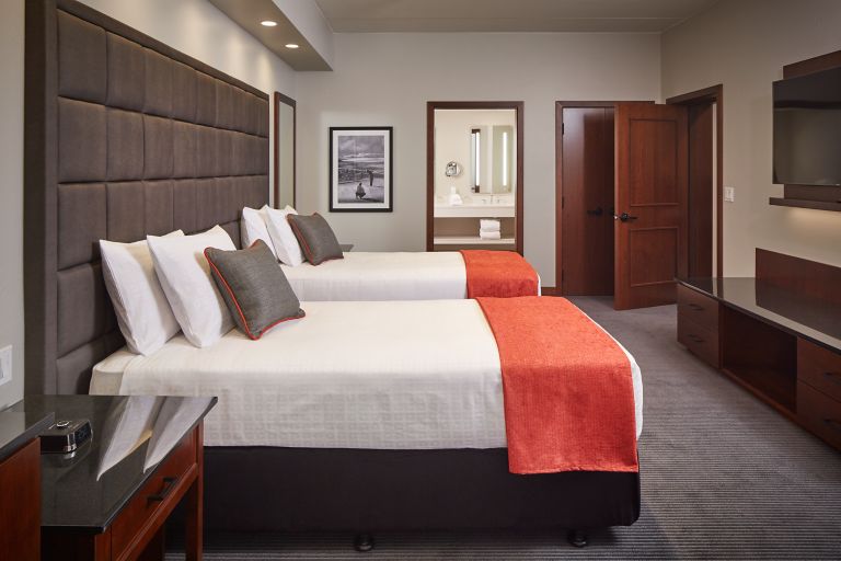 two beds and entrance to a bathroom