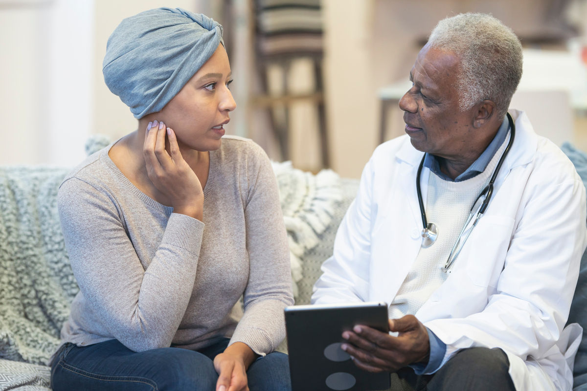 Cancer patient and provider sitting on a couch talking about results