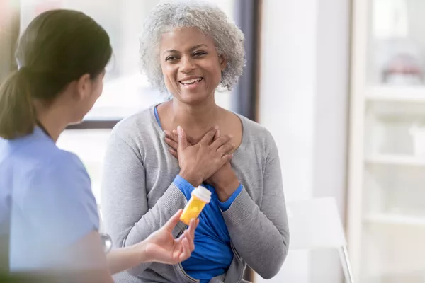 Older woman massaging her aching wrist