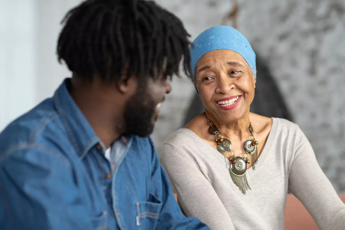 Patient and her son smiling at each other as they sit