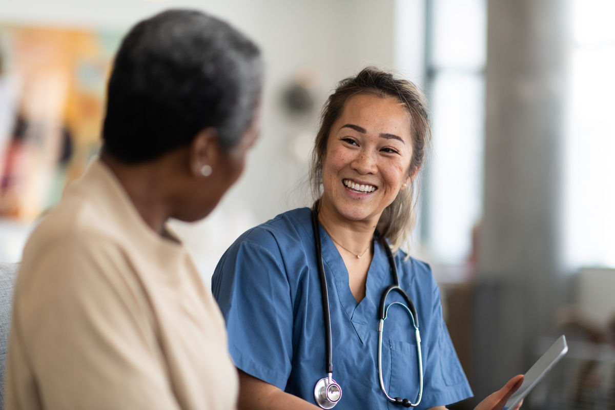 Patient sitting in a doctors office talking to a doctor