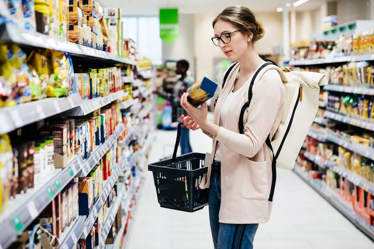 Woman looking over a label in the store.