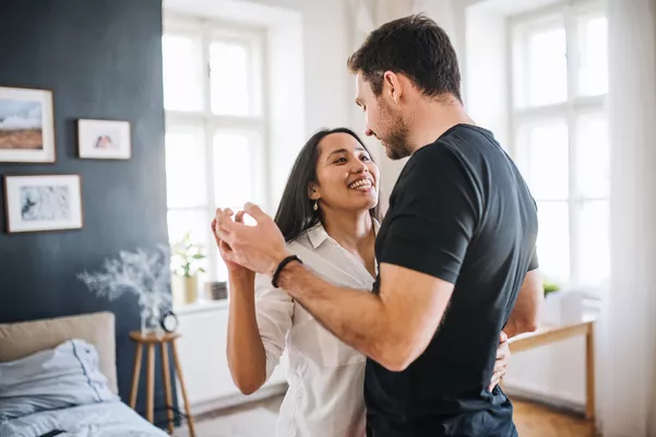 Couple dancing in their bedroom