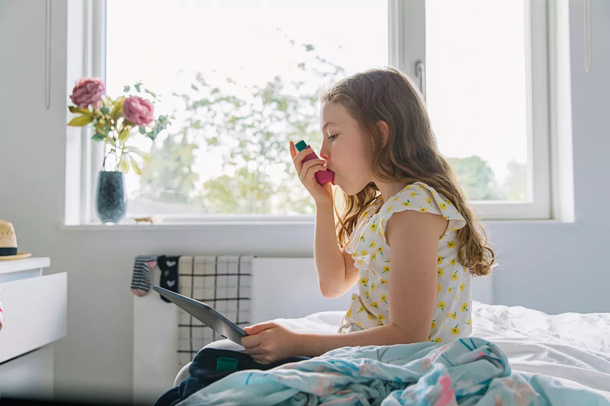 Girl taking a dose from an inhaler