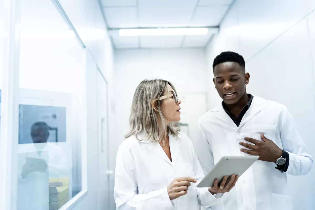 Two scientists going over results on a tablet