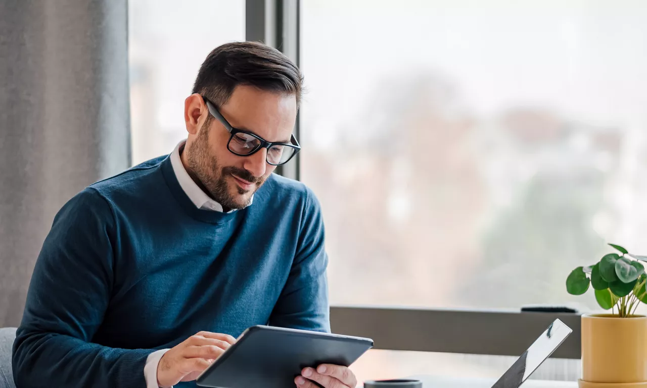 Man with glasses reviewing a document