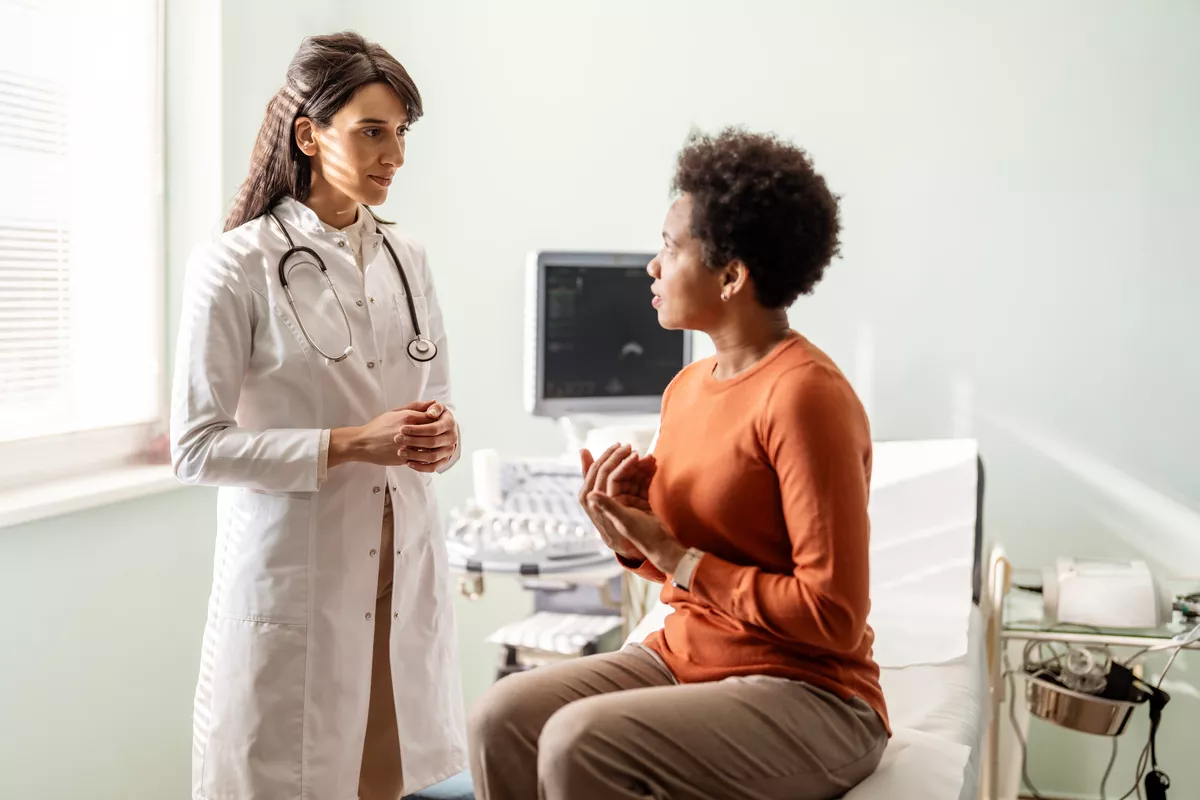 Provider and patient talking in an exam room.