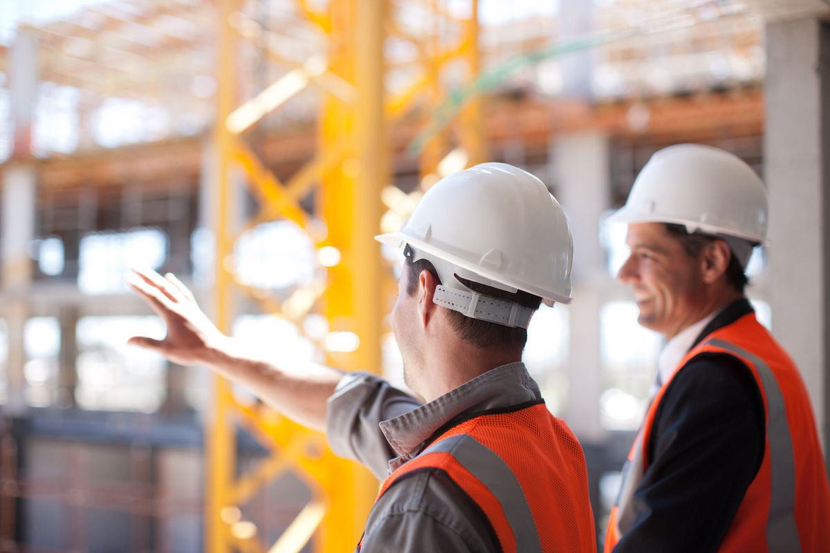 Two construction workers planning out their build