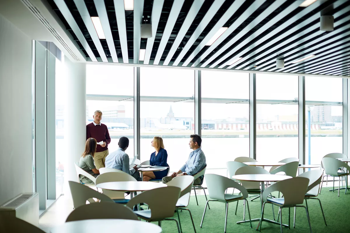 Shot of a group of colleagues talking together in a modern office