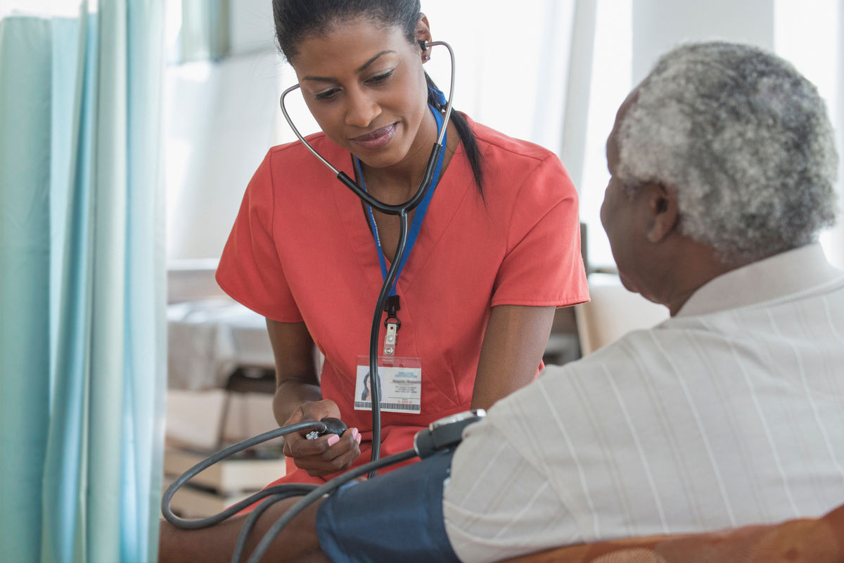 Provider measuring a patient's blood pressure