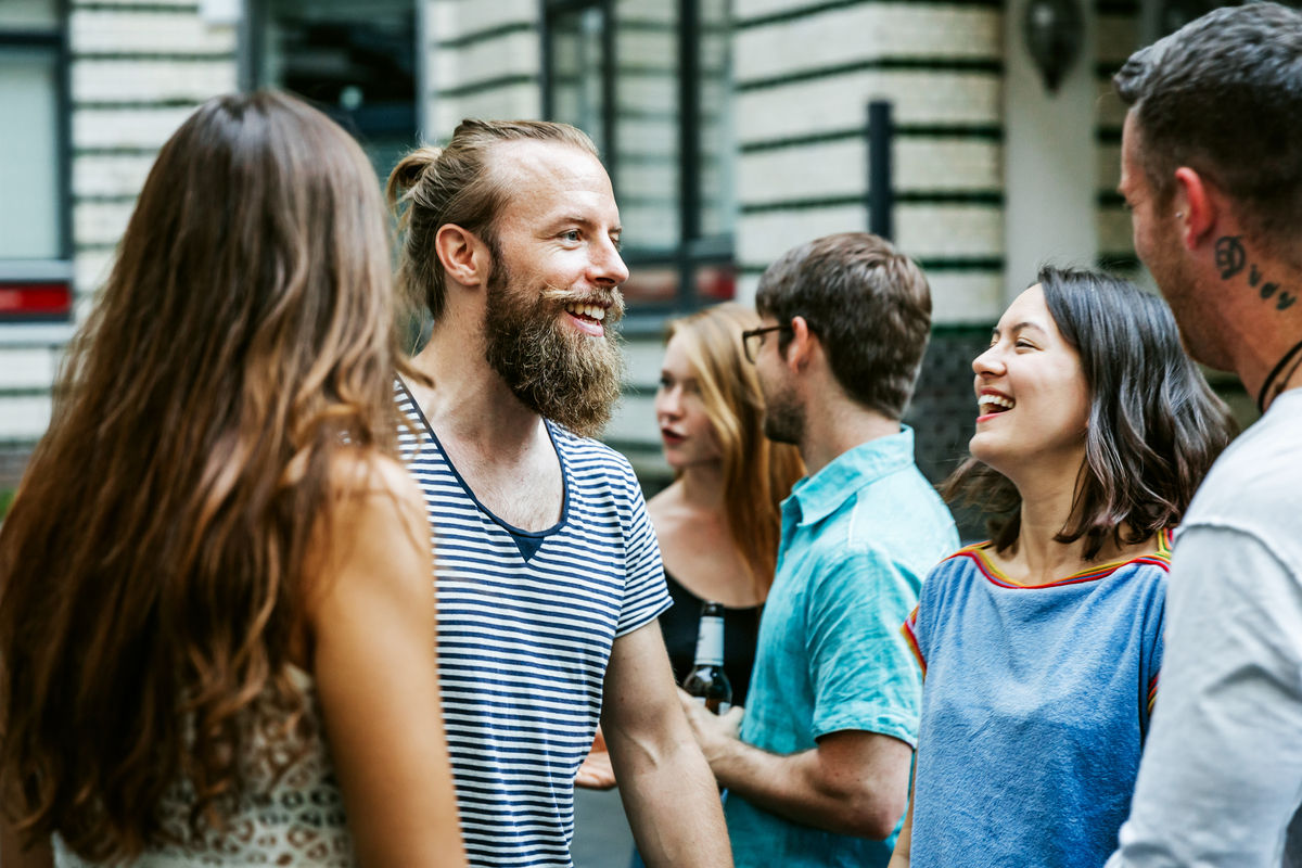 Group of friends talking outside in a city setting