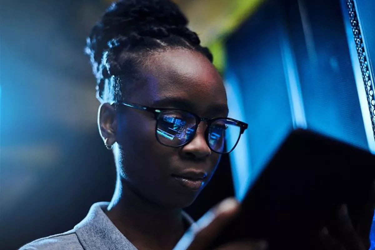 Woman looking at a tablet in a dark room