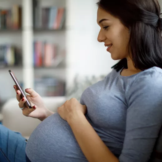 Pregnant woman holding mobile phone