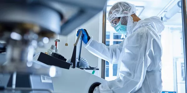 Scientist holding a pipette while extracting a specimen