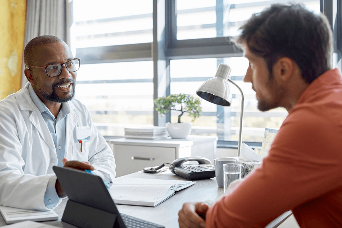 Provider meeting with a patient in his office