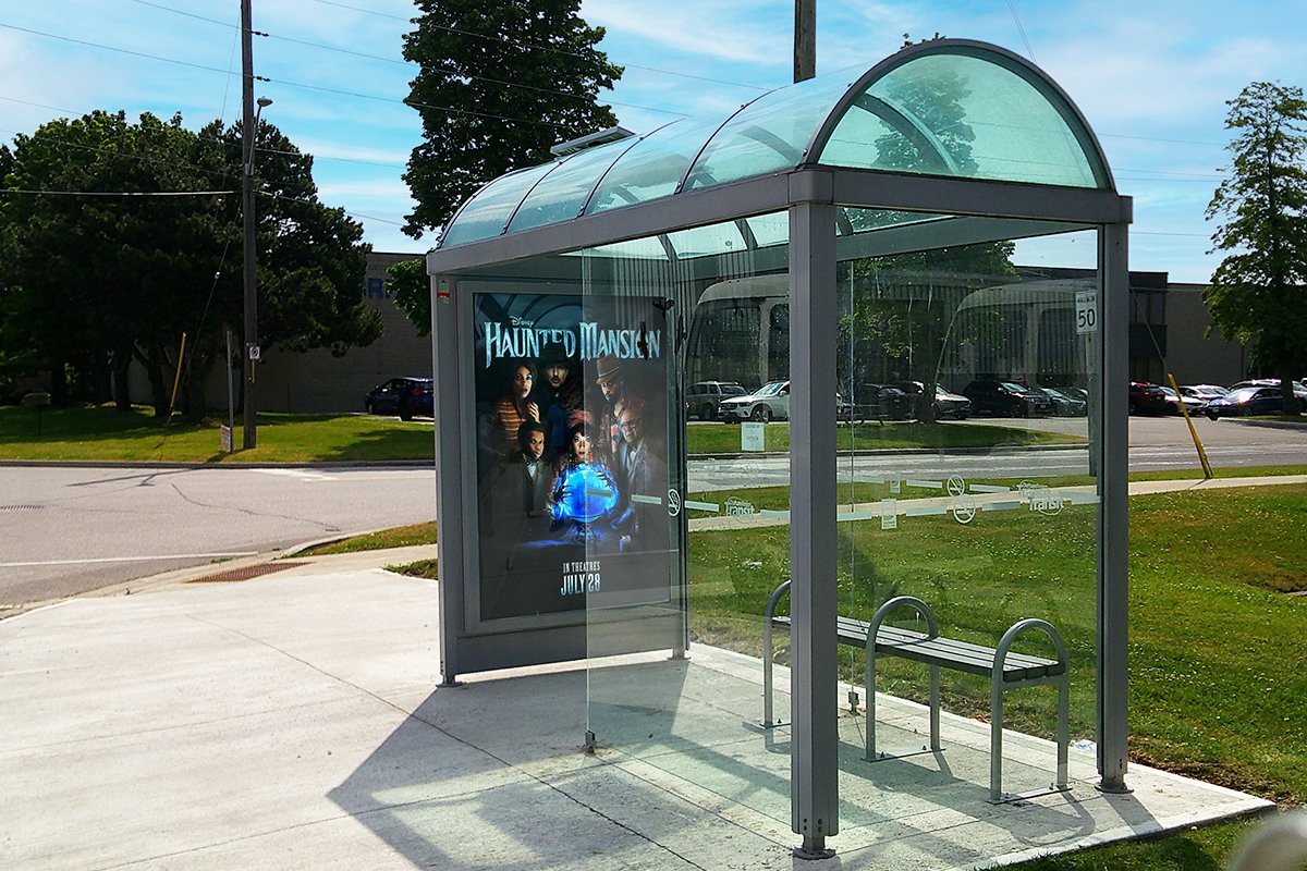 Transit shelter advertisement for Disney's Haunted Mansion on Lamar Advertising inventory in Canada.