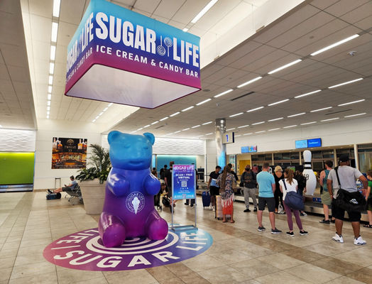 Lamar Advertising and Sugar Life baggage claim custom display in Monterey Airport 