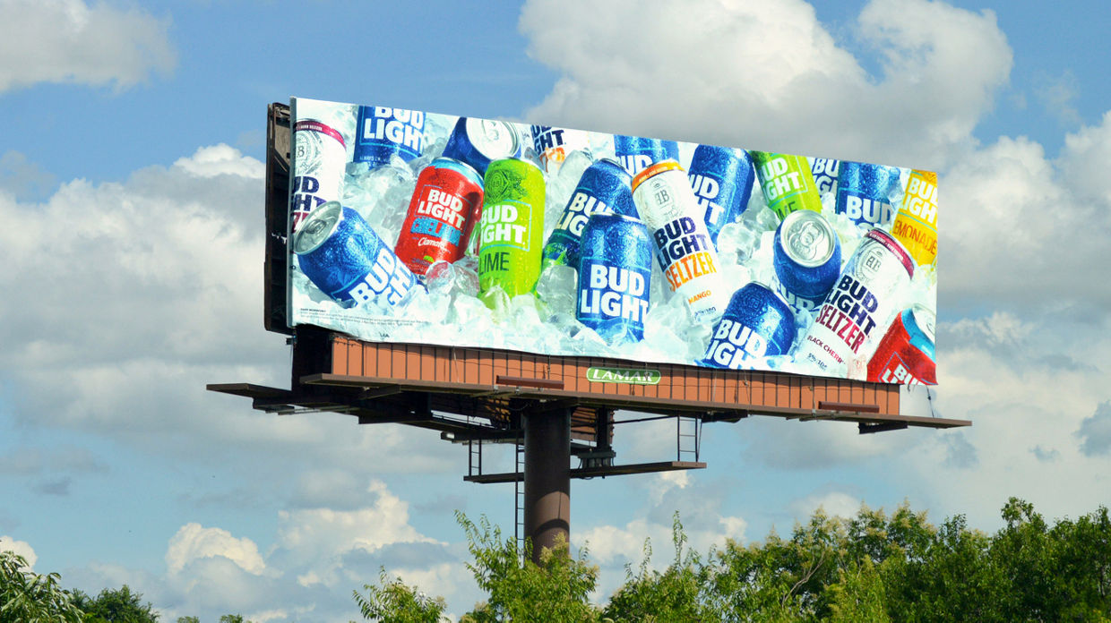 Coors Light Billboard over traffic on the highway at sunset