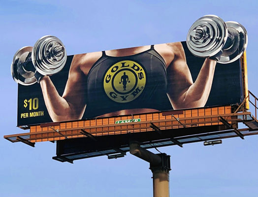 Lamar Advertising and Gold's Gym static bulletin with someone weightlifting