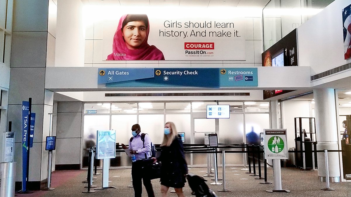 Airport ad wall display of Malala Yousafzai for PassIton.org on Lamar Advertising Inventory at Gulfport-Biloxi International 