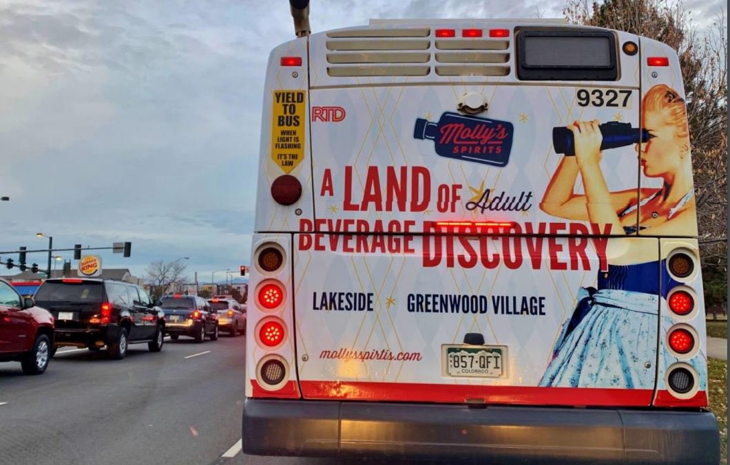 Lamar Advertising and Molly's Spirits bus exterior in Lakeside and Greenwood Village, Colorado 