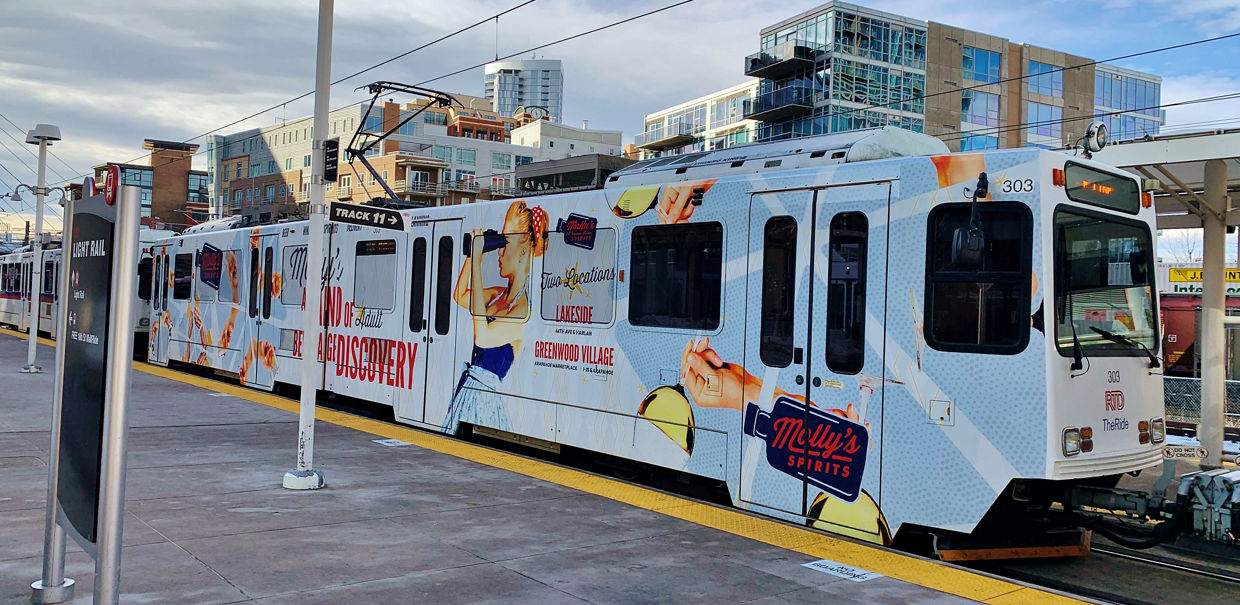 Molly's Spirits rail full wrap advertisement in Lakeside and Greenwood Village, Colorado